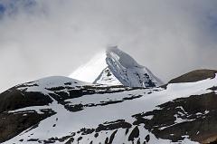 
About 30 minutes from the end of the descent from the Dolma La, a valley comes down from the Khando Sanglam La to join the main trail. This valley provides the only glimpse of the Eastern or crystal Face of Mount Kailash. The Kailash South Face is to the left and the North Face is to the right.
